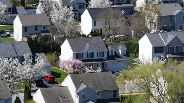 Aerial view of a suburban neighborhood with houses green lawns and blooming spring trees in a residential area Lititz Pennsylvania United States.