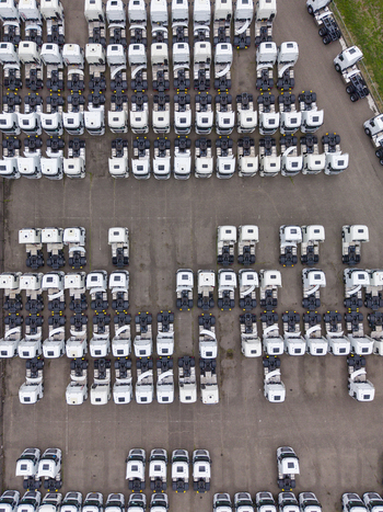 Aerial view of rows of white semi trucks parked in a large logistics lot at Ekkersrijt 2037 in Son Noord Brabant Netherlands.