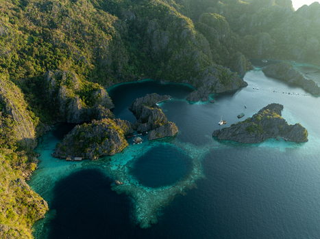 Aerial view of Twin Lagoon featuring turquoise waters limestone cliffs and lush vegetation in Coron Mimaropa Philippines. Aerial view of Twin Lagoon featuring turquoise waters limestone cliffs and lush vegetation in Coron Mimaropa Philippines.