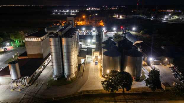Aerial view of industrial grain silos and storage facility illuminated at night in Sremska Mitrovica Vojvodina Serbia.