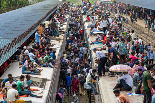 Dhaka Bangladesh 14 June 2018 View of Airport Railway Station crowded with people sitting on train roofs and platforms during a busy commuting period. Dhaka Bangladesh 14 June 2018 View of Airport Railway Station crowded with people sitting on train roofs and platforms during a busy commuting period.