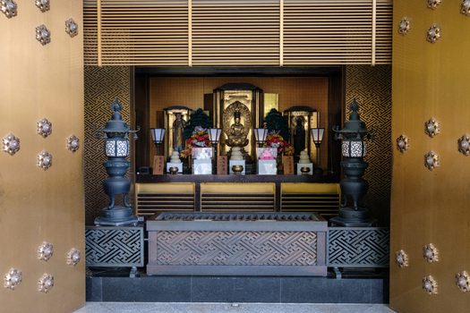 View of golden doors open to reveal an ornate altar with statues and lanterns a serene pocket of reverence Naritasan Shinsho ji Narita Chiba Japan. View of golden doors open to reveal an ornate altar with statues and lanterns a serene pocket of reverence Naritasan Shinsho ji Narita Chiba Japan.