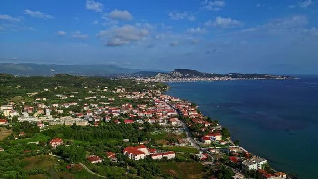 Aerial view of coastal town with red roofed houses Greece.