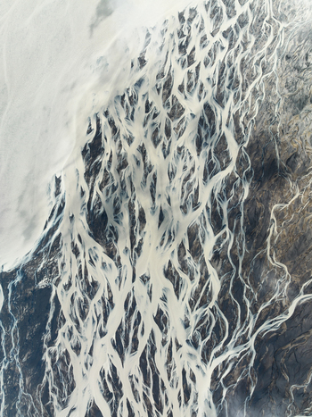Aerial view of glacial rivers carving intricate paths through a stark otherworldly landscape where icy whites meet earthy browns in a mesmerizing dance of nature Iceland Iceland. Aerial view of glacial rivers carving intricate paths through a stark otherworldly landscape where icy whites meet earthy browns in a mesmerizing dance of nature Iceland Iceland.