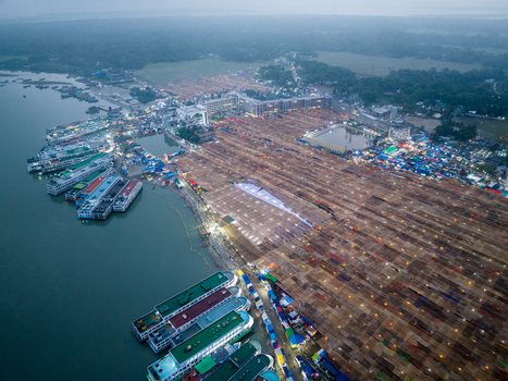 Aerial view of a vibrant gathering near the riverbank where lights twinkle against the dusk illuminating a vast textured landscape Charmonai Bangladesh. Aerial view of a vibrant gathering near the riverbank where lights twinkle against the dusk illuminating a vast textured landscape Charmonai Bangladesh.