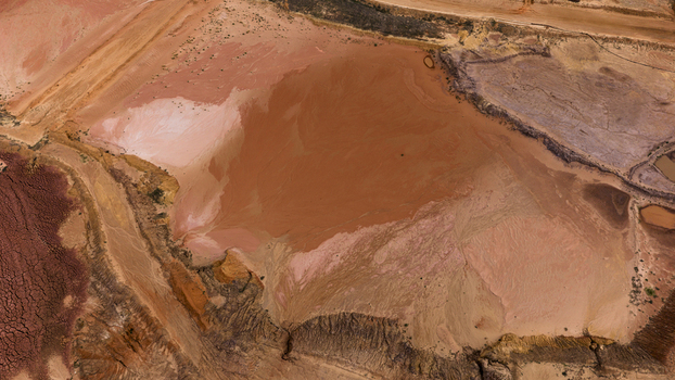 Aerial view of salt production ponds and sand patterns featuring vibrant earth tones and textured terrain in Kalbarri Western Australia Australia. Aerial view of salt production ponds and sand patterns featuring vibrant earth tones and textured terrain in Kalbarri Western Australia Australia.