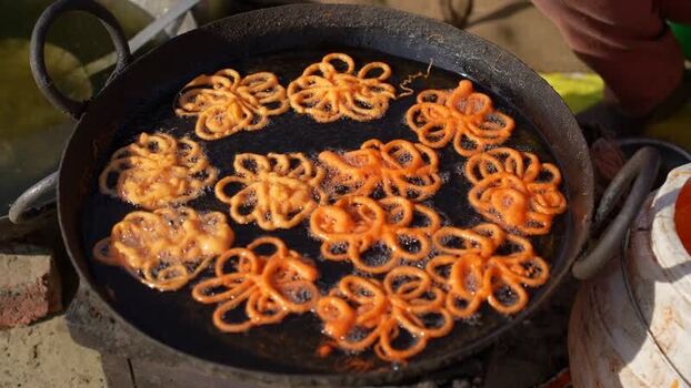 View of traditional jalebi sweets frying in hot oil Nepal.