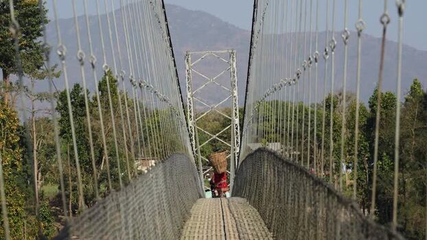View of a person crossing a suspension bridge in Surkhet Nepal.