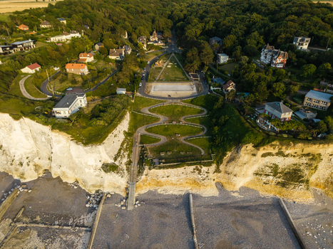 Aerial view of the Beach of the Bois de Cise with its winding paths lush green park and historic villas nestled along the white chalk cliffs in Ault Hauts de France France.