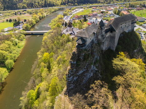 Aerial view of Orava Castle perched on a steep rock cliff overlooking the Orava River and surrounding lush green forest in Dolny Kubin Zilinsky kraj Slovakia. Aerial view of Orava Castle perched on a steep rock cliff overlooking the Orava River and surrounding lush green forest in Dolny Kubin Zilinsky kraj Slovakia.