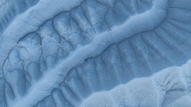 Aerial view of the intricate eroded ridges and deep gullies of the badlands landscape in the desert terrain Hanksville Utah United States.