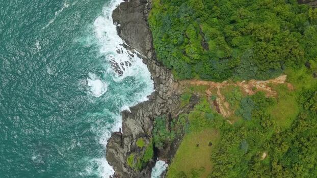 Aerial view of Bukit Pengilon cliffs and crashing waves Indonesia.