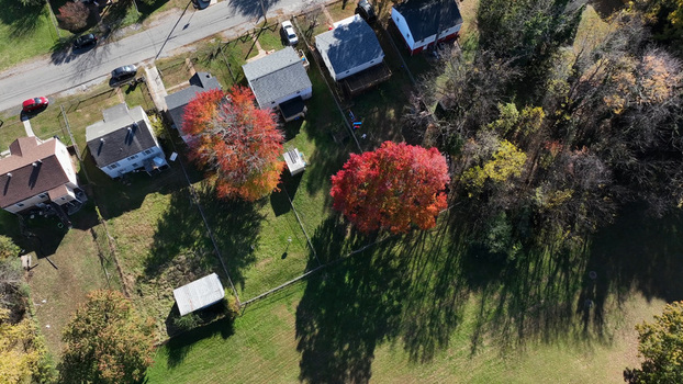 Aerial view of residential houses surrounded by vibrant autumn trees and green lawns in Lynchburg Virginia United States. Aerial view of residential houses surrounded by vibrant autumn trees and green lawns in Lynchburg Virginia United States.