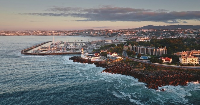 Aerial view of the Santa Marta Lighthouse and marina along the rocky coastline at sunset in Lisbon Lisbon Portugal. Aerial view of the Santa Marta Lighthouse and marina along the rocky coastline at sunset in Lisbon Lisbon Portugal.