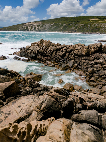 Aerial view of Injidup Natural Spa featuring rugged rock formations turquoise ocean waves crashing against the shore and a lush green coastline in Yallingup Western Australia Australia. Aerial view of Injidup Natural Spa featuring rugged rock formations turquoise ocean waves crashing against the shore and a lush green coastline in Yallingup Western Australia Australia.