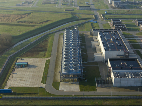 Aerial view of the Nitrogen plant featuring cooling towers and industrial buildings surrounded by green fields in Zuidbroek Groningen Netherlands. Aerial view of the Nitrogen plant featuring cooling towers and industrial buildings surrounded by green fields in Zuidbroek Groningen Netherlands.