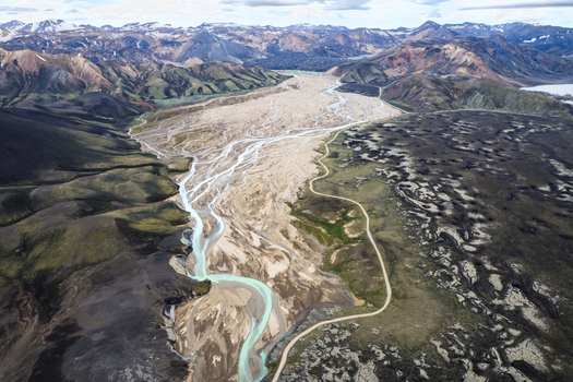 Aerial view of the braided glacial river system and the winding F208 road through the rugged volcanic landscape Icelandic Highlands Iceland. Aerial view of the braided glacial river system and the winding F208 road through the rugged volcanic landscape Icelandic Highlands Iceland.