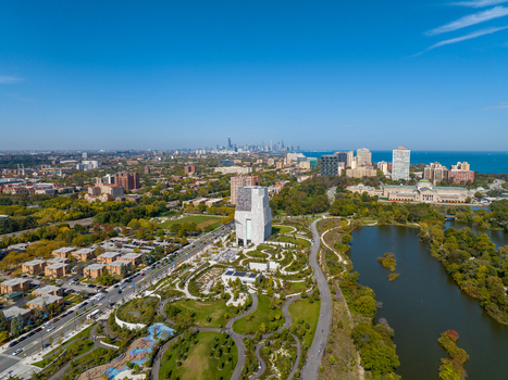 Aerial view of The Obama Presidential Center surrounded by lush parkland winding pathways and the Chicago skyline in the distance Chicago Illinois United States. Aerial view of The Obama Presidential Center surrounded by lush parkland winding pathways and the Chicago skyline in the distance Chicago Illinois United States.