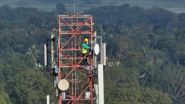 Aerial view of a technician on a telecommunications tower Bangladesh.
