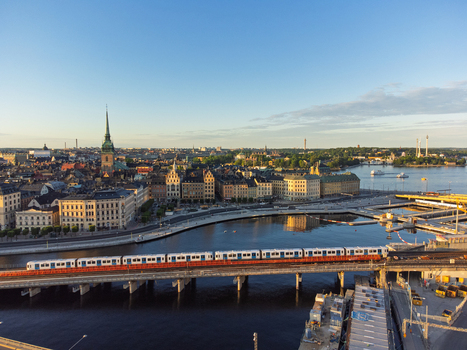 Aerial view of Vattentorget Slussen with a train crossing the bridge historic buildings and waterfront in Slussen Stockholms lan Sweden.