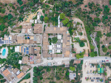 Aerial view of the village featuring terracotta rooftops a central courtyard with outdoor seating a swimming pool and surrounding greenery San Vito Lo Capo Sicilia Italy. Aerial view of the village featuring terracotta rooftops a central courtyard with outdoor seating a swimming pool and surrounding greenery San Vito Lo Capo Sicilia Italy.