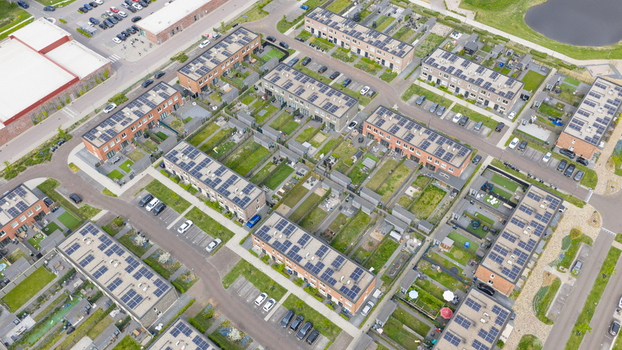 Aerial view of the modern Nobelhorst neighborhood featuring houses with solar panels and green gardens in Almere Flevoland Netherlands. Aerial view of the modern Nobelhorst neighborhood featuring houses with solar panels and green gardens in Almere Flevoland Netherlands.