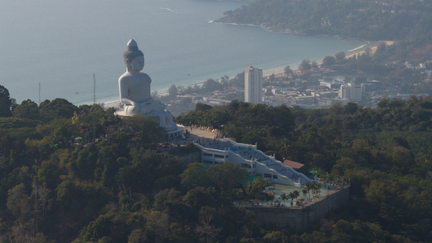 Aerial view of the Big Buddha Phuket statue on a lush hilltop overlooking the coastline and turquoise waters Karon Phuket Thailand. Aerial view of the Big Buddha Phuket statue on a lush hilltop overlooking the coastline and turquoise waters Karon Phuket Thailand.