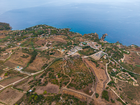 Aerial view of the coastal landscape featuring rolling hills scattered buildings and the Mediterranean Sea in Palermo Sicily Italy. Aerial view of the coastal landscape featuring rolling hills scattered buildings and the Mediterranean Sea in Palermo Sicily Italy.