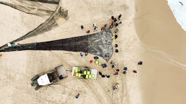 Aerial view of fishermen with nets on the beach Portugal. Aerial view of fishermen with nets on the beach Portugal.