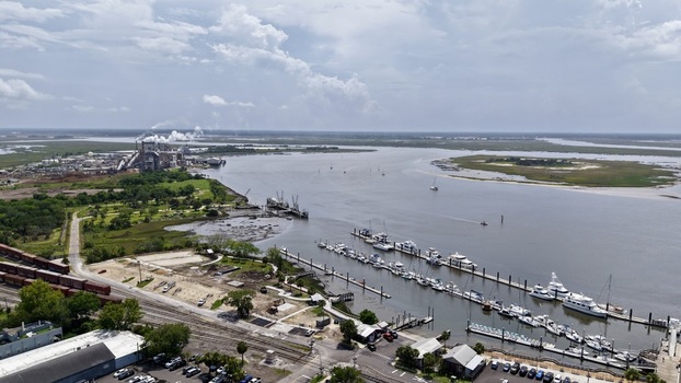 Aerial view of a marina full of boats train tracks and a distant industrial plant on the river Fernandina Beach Florida United States. Aerial view of a marina full of boats train tracks and a distant industrial plant on the river Fernandina Beach Florida United States.