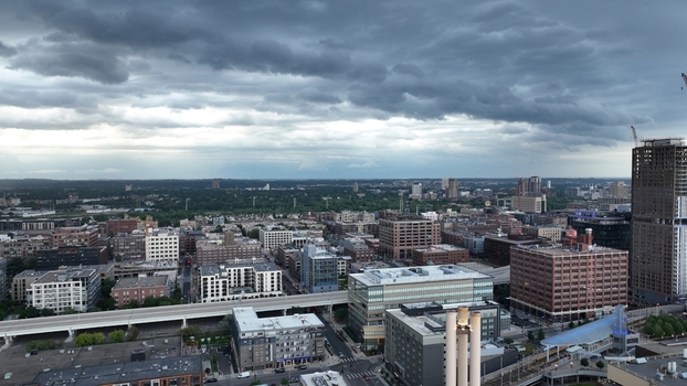 Aerial view of a cityscape where light breaks through storm clouds over buildings and a highway Austin USA.