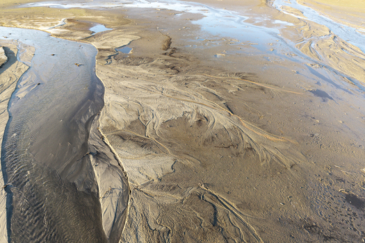 Aerial view of intricate sand textures and water channels in a riverbed in Poland. Aerial view of intricate sand textures and water channels in a riverbed in Poland.