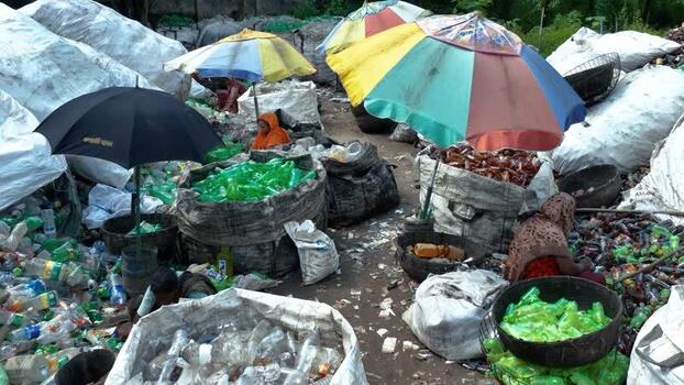 View of workers sorting plastic bottles in Bogura Bangladesh. View of workers sorting plastic bottles in Bogura Bangladesh.