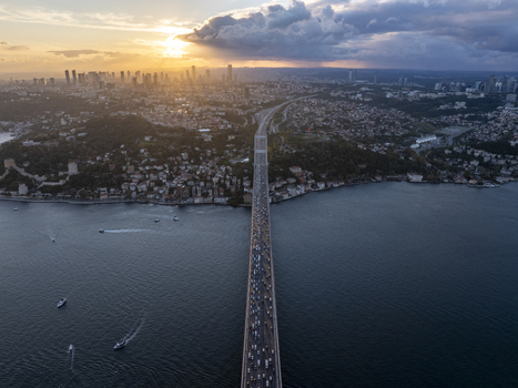 Aerial view of Fatih Sultan Mehmet Bridge spanning the Bosphorus at sunset with heavy traffic urban skyline and boats on the water Beykoz Istanbul Turkiye. Aerial view of Fatih Sultan Mehmet Bridge spanning the Bosphorus at sunset with heavy traffic urban skyline and boats on the water Beykoz Istanbul Turkiye.