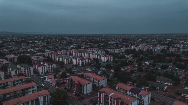 Aerial view of SSNIT Flat residential complex with apartment blocks paved roads and lush greenery under a cloudy sky in Adenta Municipality Greater Accra Region Ghana. Aerial view of SSNIT Flat residential complex with apartment blocks paved roads and lush greenery under a cloudy sky in Adenta Municipality Greater Accra Region Ghana.
