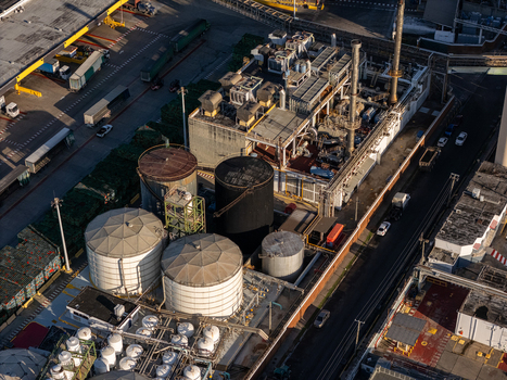 Aerial view of the beer industrial complex featuring large storage tanks industrial machinery and trucks parked within the facility in Santo Domingo Dominican Republic. Aerial view of the beer industrial complex featuring large storage tanks industrial machinery and trucks parked within the facility in Santo Domingo Dominican Republic.