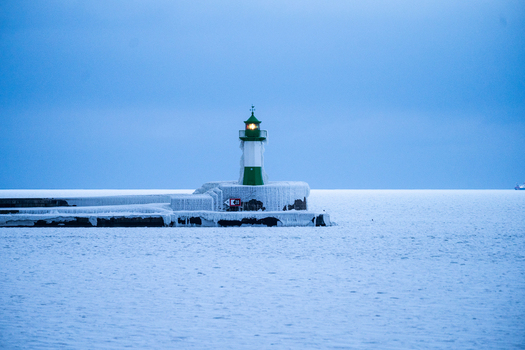 View of Molenfeuer Sassnitz surrounded by thick ice and snow on the pier in the frozen Baltic Sea in Sassnitz Mecklenburg Vorpommern Germany.