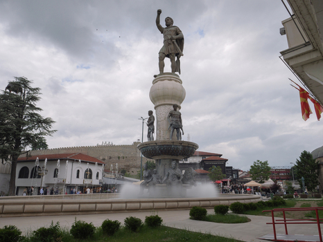 View of the Warrior on a Horse statue standing atop a fountain with surrounding historic architecture and a cloudy sky in Skopje Greater Skopje North Macedonia. View of the Warrior on a Horse statue standing atop a fountain with surrounding historic architecture and a cloudy sky in Skopje Greater Skopje North Macedonia.