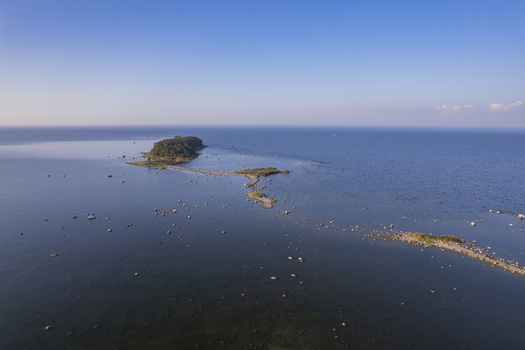 Aerial view of Kuradi saar a small island with rocky shoals and shallow waters in the Baltic Sea near the coast of Kasmu Laane Viru County Estonia.