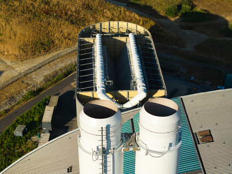 Aerial view of the Energy Recovery Facility with prominent white chimneys and industrial rooftops in Bicester England United Kingdom.