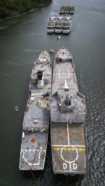 Aerial view of warships docked in a serene harbor the dark hulls contrasting with the shimmering water Landévennec France. Aerial view of warships docked in a serene harbor the dark hulls contrasting with the shimmering water Landévennec France.