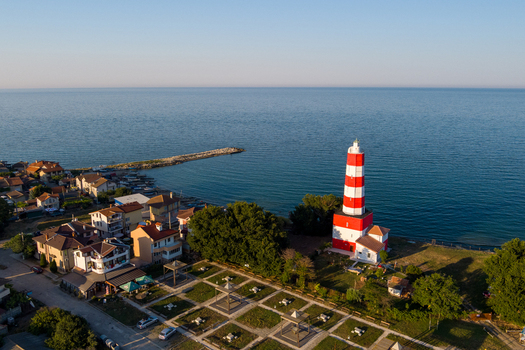 Aerial view of the red and white striped lighthouse standing on the coast near the town of Saints Constantine and Helena Varna Bulgaria.