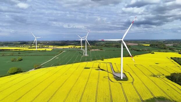 Aerial view of wind turbines and yellow rapeseed fields Germany. Aerial view of wind turbines and yellow rapeseed fields Germany.