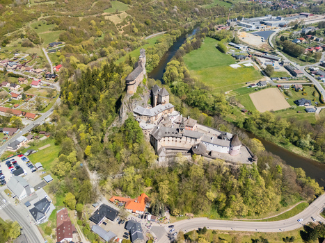 Aerial view of Orava Castle perched on a steep rock cliff overlooking the Orava river and lush spring forests in Dolny Kubin Zilinsky kraj Slovakia. Aerial view of Orava Castle perched on a steep rock cliff overlooking the Orava river and lush spring forests in Dolny Kubin Zilinsky kraj Slovakia.