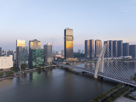Aerial view of the modern Thu Thiem 2 Bridge spanning the Saigon River with the urban skyline and skyscrapers under a clear sky in Ho Chi Minh City Ho Chi Minh Vietnam. Aerial view of the modern Thu Thiem 2 Bridge spanning the Saigon River with the urban skyline and skyscrapers under a clear sky in Ho Chi Minh City Ho Chi Minh Vietnam.