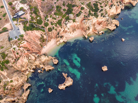 Aerial view of Praia do Camilo a beautiful paradise beach along the coast with scenic cliffs near Ponta da Piedade Lagos Algarve region Portugal.