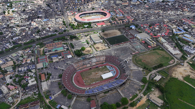 Aerial view of National Stadium Surulere Lagos and Teslim Balogun Stadium surrounded by urban sprawl and busy roads in Lagos Lagos Nigeria.