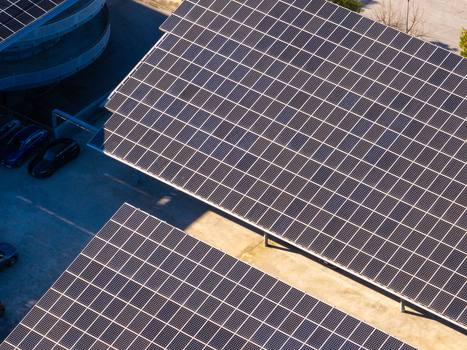 Aerial view of solar panels installed on a parking lot structure with cars parked underneath in Ancona Marche Italy. Aerial view of solar panels installed on a parking lot structure with cars parked underneath in Ancona Marche Italy.