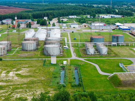 Olaine parish Latvia 04 July 2026 Aerial view of an industrial facility featuring large storage tanks pipelines and surrounding green fields in Olaine parish. Olaine parish Latvia 04 July 2026 Aerial view of an industrial facility featuring large storage tanks pipelines and surrounding green fields in Olaine parish.