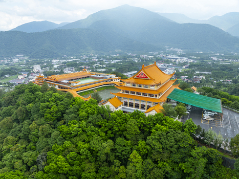 Aerial view of the Chung Tai Chan Monastery with its golden roof architecture set against lush green forests and mountain scenery Puli Township Nantou County Taiwan. Aerial view of the Chung Tai Chan Monastery with its golden roof architecture set against lush green forests and mountain scenery Puli Township Nantou County Taiwan.